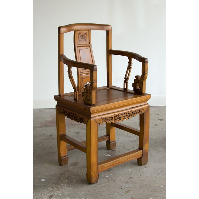 A Chinese southern official's hat armchair (nanguanmaoyi) in pale golden elm, with a gently curved crest rail, S-curved...