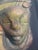 “Timeless Connection” is a ceramic wall sculpture by Everard Powell featuring two stylized faces rendered in luminous...