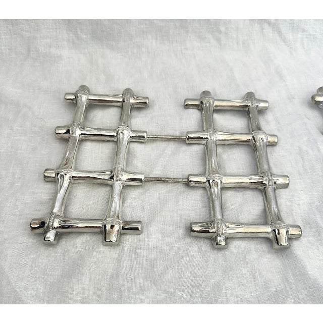 Vintage pair of silver faux bamboo trivets that can expand. Perfect for those hot dishes. 7.25in square to 8.75 when...