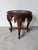 Striking Anglo Indian carved wood side table featuring four sculptural elephant supports with detailed trunks, tusks, and...