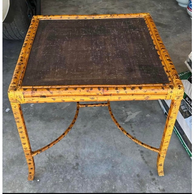 Beautiful vintage side table in excellent pre-owned condition. This striking piece features a lacquered grasscloth top...