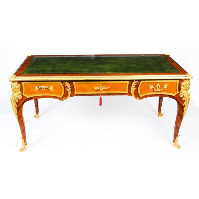 This is a gorgeous antique French Louis Revival gilt bronze mounted amaranth bureau plat, Circa 1880 in date. The...