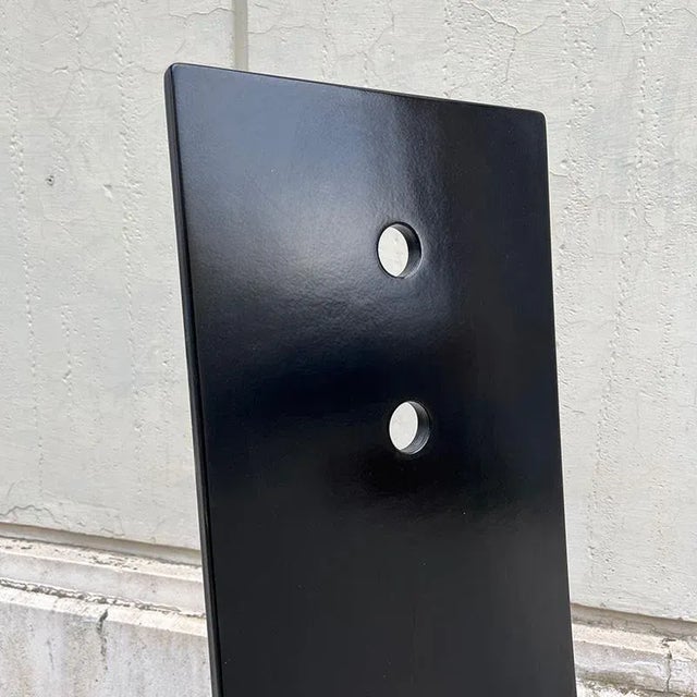 Chair with a 140 cm high backrest, made of black, iron and steel wood. It has a very singular design with a narrow back, a...