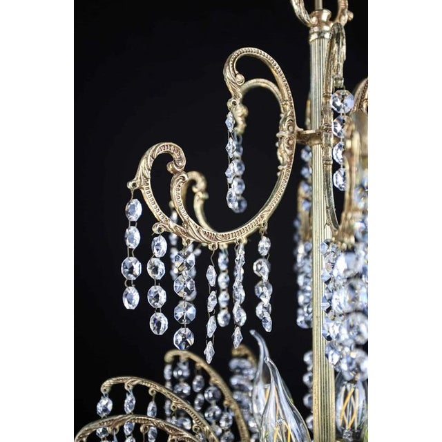 Smaller chandelier made of cast brass with plant decor. Interesting two-tier design with hand-cut and polished trimmings...