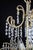 Smaller chandelier made of cast brass with plant decor. Interesting two-tier design with hand-cut and polished trimmings...