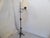 This iron floor lamp uses a an Edison base bulb up to 100 Watts. It is shown with a shade that measures 13" Diameter x...