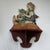 Absolutely charming vintage wooden wall shelf featuring a whimsical hand painted scene of a young girl baking with a...