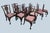 Wonderful set of 10 Chippendale style dark wood frame dining chairs. Eight of the chairs are side chairs with a slightly...