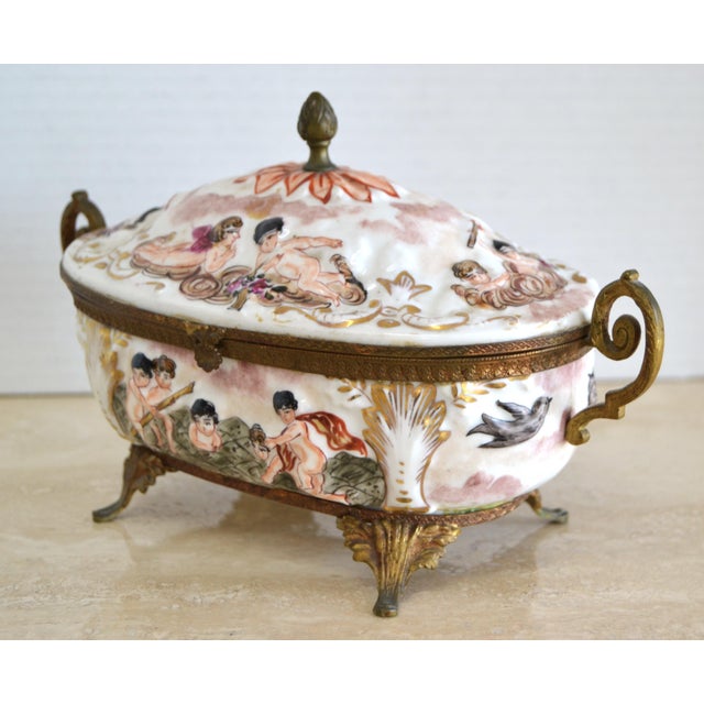 French Hand-Painted Lidded Decorative Porcelain and Brass Bowl with Angel Motives. Makers Mark at the Base. In good...