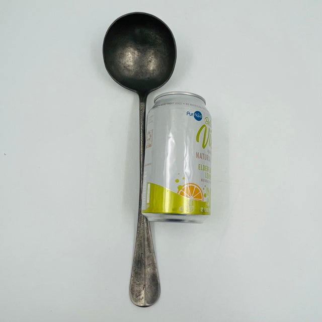 Antique early 19th-century German pewter ladle marked "Bachmann Zinnstahl" with an eagle hallmark. Measures 12" long by 3"...