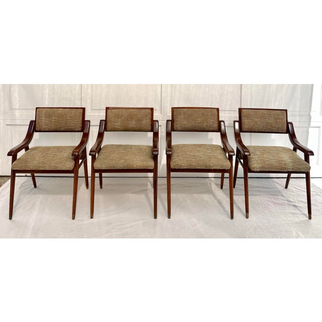 Here is a wonderful set of FOUR dining chairs made in the mid-century, featuring all the great design elements you expect...