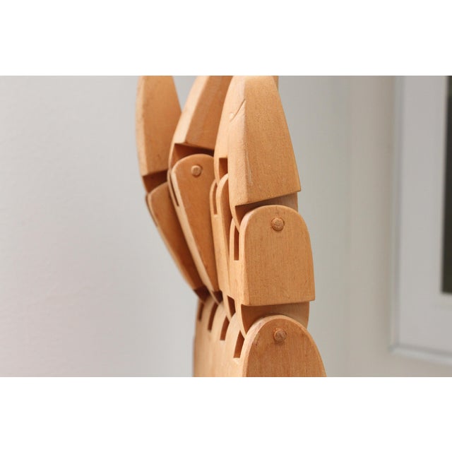 Large handmade articulating hand and cuff. Signed M. George 1990. All wood including pins. Signs of age. Fingers...
