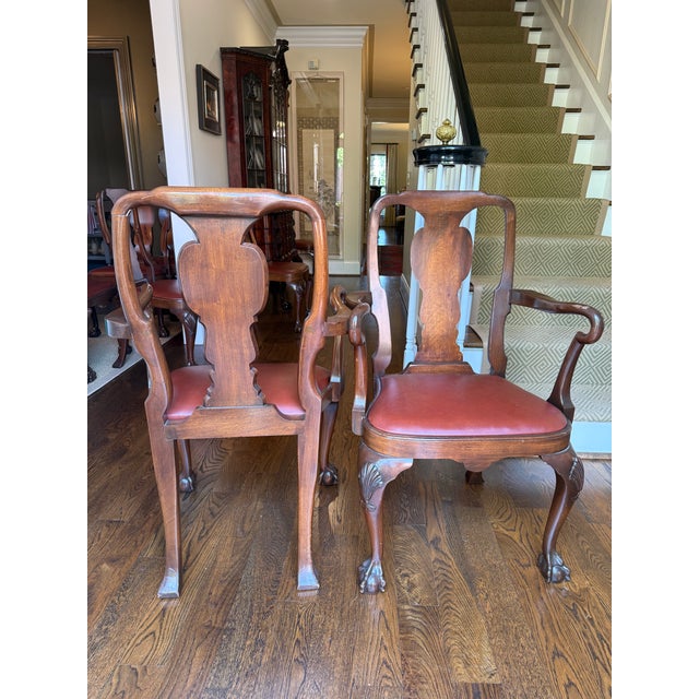 Pretty Queen Anne dining chairs featuring splat backs, ball and claw feet, and carved wooden cabriole legs with a shell...