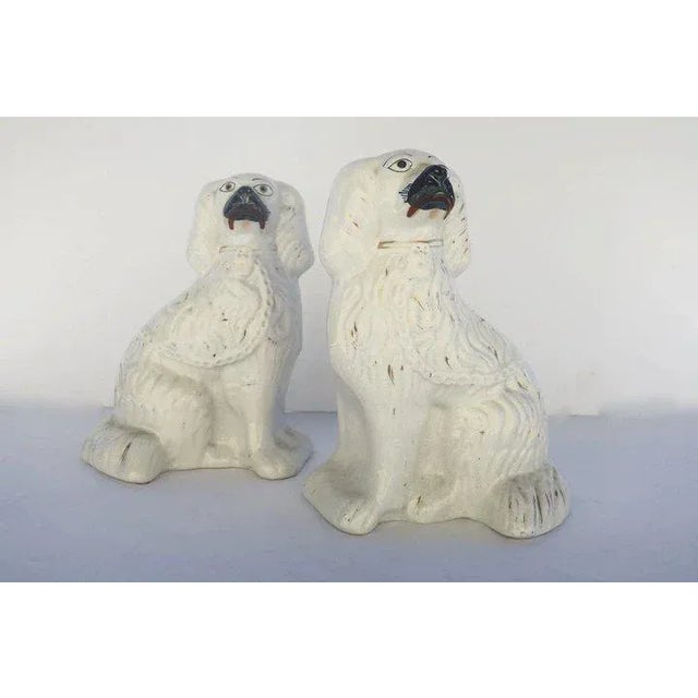 Pair of 19th century English Staffordshire spaniels dogs. Originally used on mantels the dogs pair by facing each other....