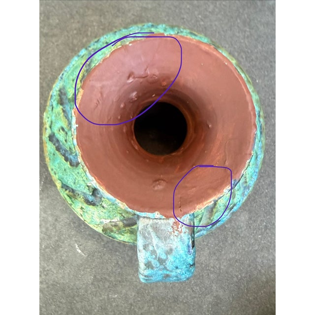 Clay ewer with sgraffito design with blue, green, yellow and red lava glaze. The bottom is stamped “Made in Italy”.