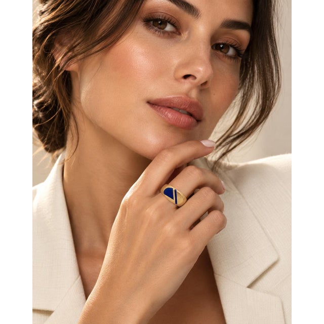 An authentic and distinguished vintage signet statement ring masterfully crafted in solid 14k yellow gold. Highlighting a...