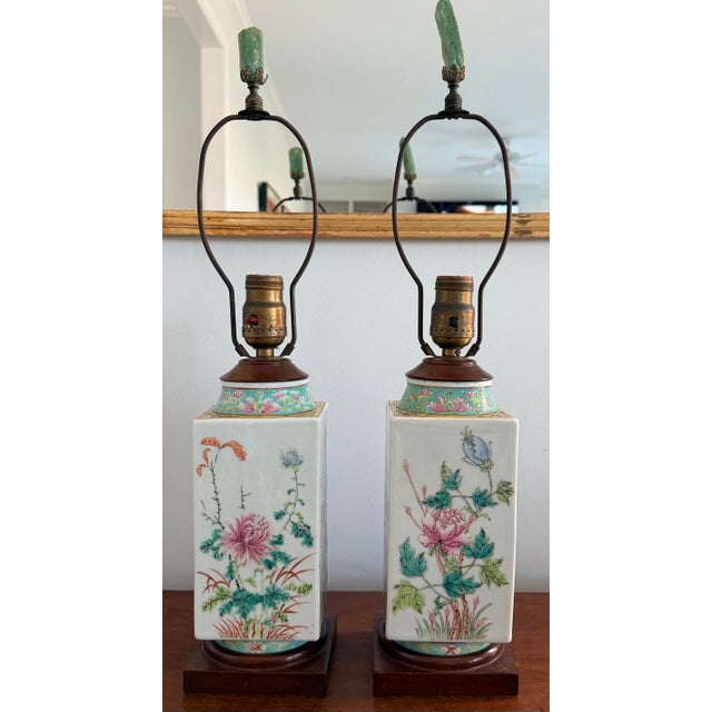 Pair of chinoiserie style table lamps. Pastel blues and pinks with yellow and blue green accents. Wonderful Jade finials....