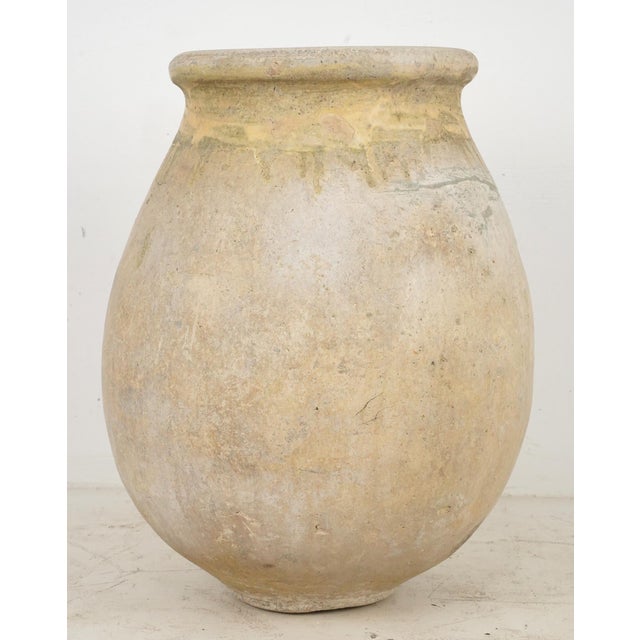 19th century olive jar made of blond terra cotta clay with a natural glaze. It was made in Biot, Provence, France, where...