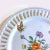 A beautiful porcelain decorative hanging plate with reticulated boarder and a pretty floral pattern in the middle. Welcome...