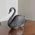 A vintage detailed silver-tone metal swan figurine with an open slot/reservoir back, perfect for use as a table napkin...
