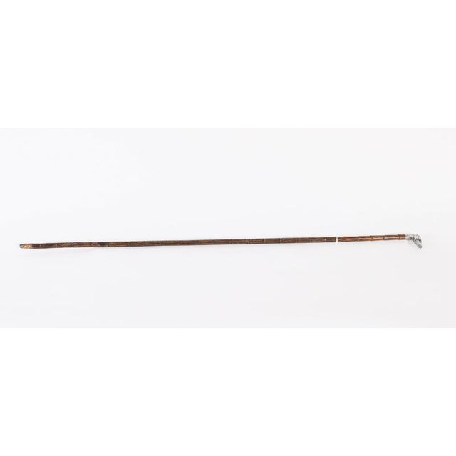 A superb antique sterling silver greyhound handled walking stick with hallmarks for Thomas William Dee, London, 1897. It...