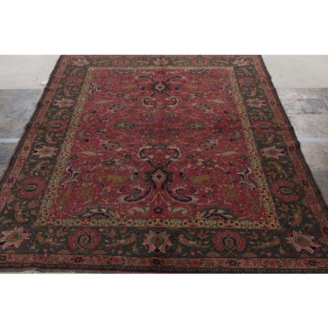 Finely woven in wool, an unusual antique 7x9 Agra rug originating from India circa 1900-1920. Carrying Persian...