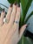 A 0.67-carat blue montana sapphire oval sits at the centre of this solid 14K white gold ring, framed by eight earth-mined...