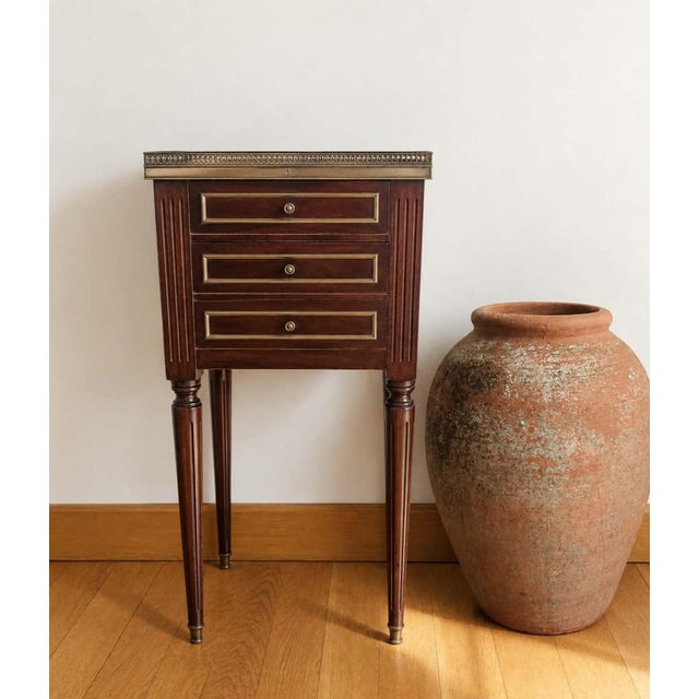 Louis XVI style mahogany chiffonier or bedside table, early 20th century (circa 1900). Tapered and fluted legs, three...