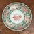 antique ceramic or porcelain dish featuring red and green overglaze enamel decoration with mythical animals (such as qilin...