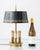 Elegant French Empire-style bouillotte lamp with polished brass base, three candle lights, and teal crackle-finish metal...