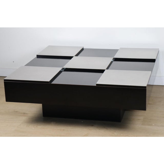 A beautiful square coffee table with a graphic design typical of the 1970s, featuring an elegant checkerboard top...