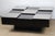 A beautiful square coffee table with a graphic design typical of the 1970s, featuring an elegant checkerboard top...