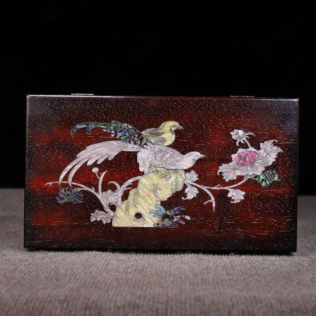 A beautifully crafted Chinese rectangular box, likely made of Zitan wood. The box features a hinged lid with brass...
