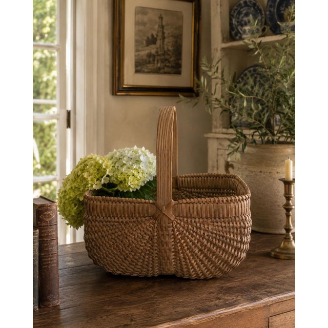 A beautifully crafted vintage gathering basket woven in the Nantucket tradition, with a softly rounded rectangular body...