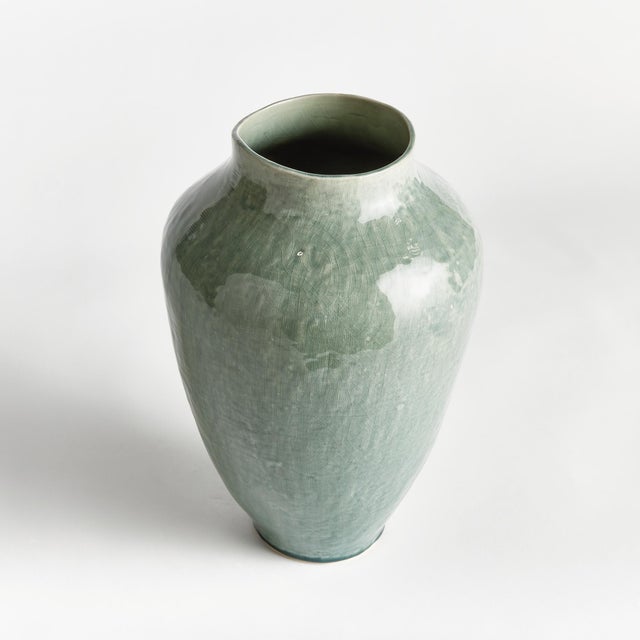 In a modern silhouette with a subtle linenlike texture, reactive glaze and high gloss finish, this ceramic vase is a...