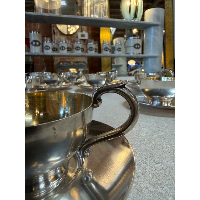 Refined Italian Tea service in silver plate, composed of twelve cups and matching saucers, crafted in a classic mid-...
