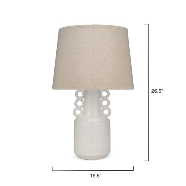 This versatile table lamp lends visual interest to any tabletop. Hand crafted of natural ceramic and finished in white for...