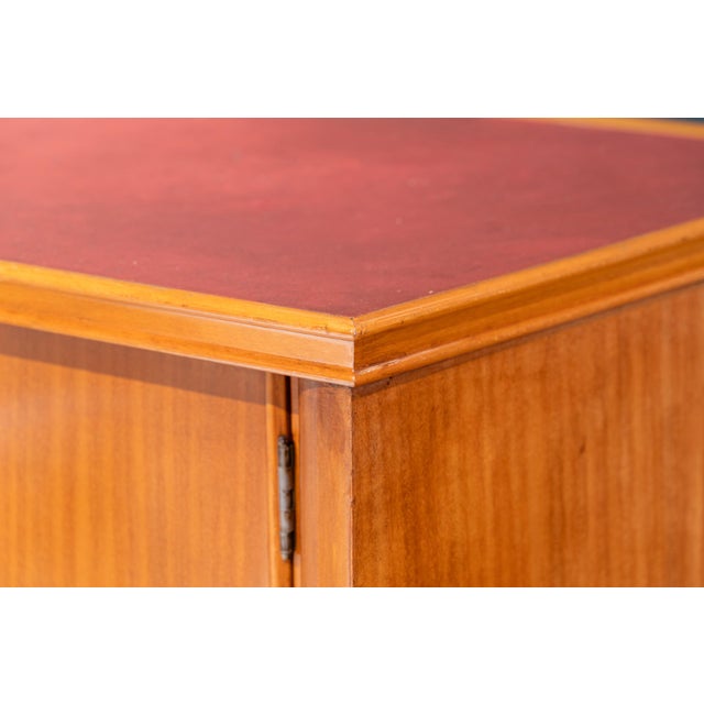 A mid-century Italian sideboard from the 1950s, crafted from walnut. The elongated rectangular structure rests on four...