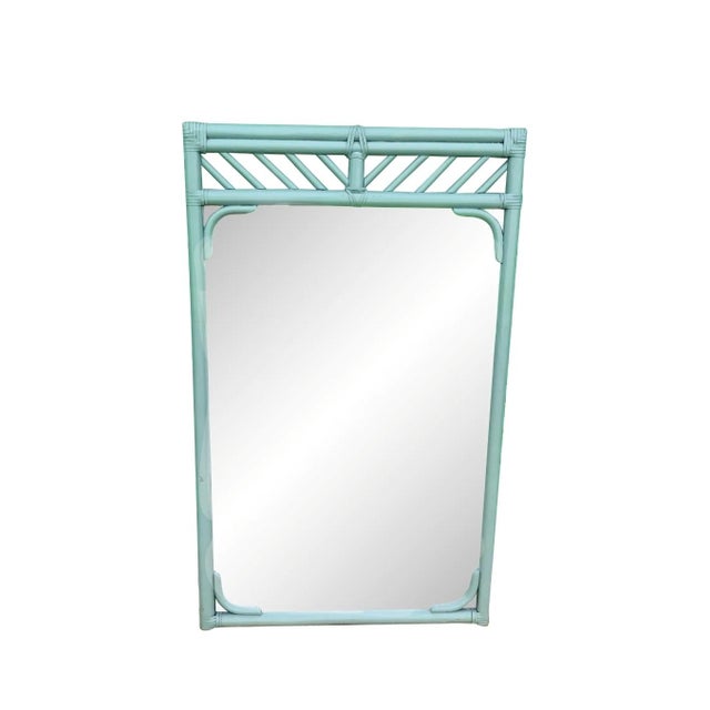A beautiful vintage wall mirror in the style of Ficks Reed. The mirror is in a slightly hard to describe dusty blue grey...