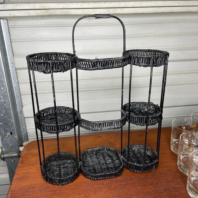 Black wicker and metal barware caddy. Can hold lowball glasses and a bottle of your favorite liquor or wine. In.good...