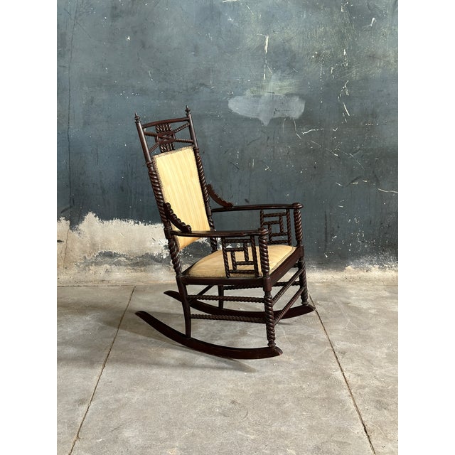 19th century Victorian hardwood rocking chair with barley twist details and prominent finials.