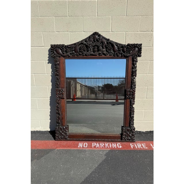 Exceptional large antique carved oak mirror featuring highly detailed hand-carved decoration throughout the frame. The...