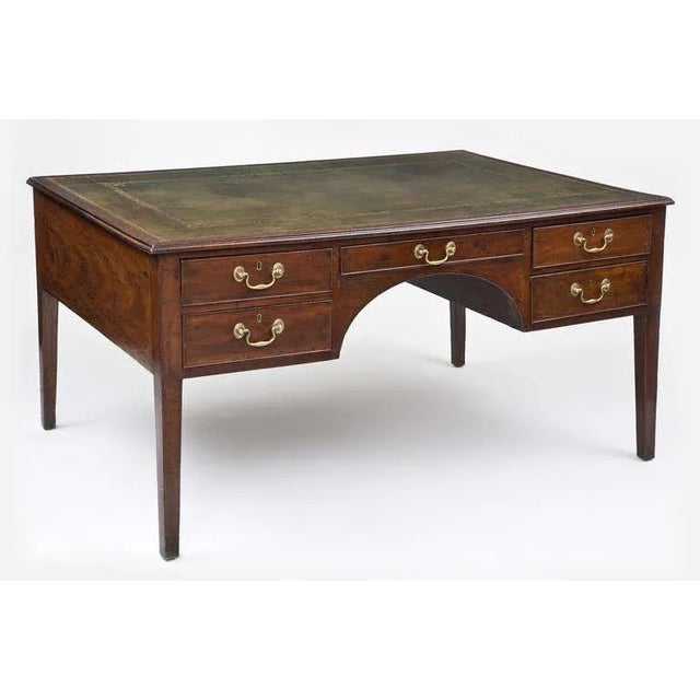 George III mahogany partners writing table/desk, the rectangular top with molded edge, having ten drawers, olive green...