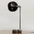 A 1960s black and silver desk lamp with movable head . This piece is attributed to the mentioned designer/maker. It has no...