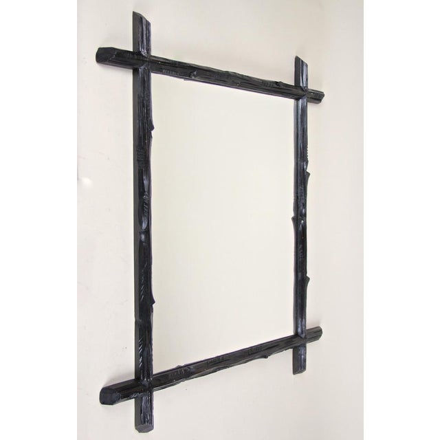 Decorative rustic Black Forest wall mirror from the late 19th century circa 1880 in Austria. A unique lovely hand carved...