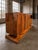 A striking Art Deco sideboard crafted in richly figured walnut veneer, showcasing a bold symmetrical grain pattern and...