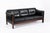 This vintage mid century Danish modern black leather three-seat sofa in the style of Arne Norell is circa 1970. This...