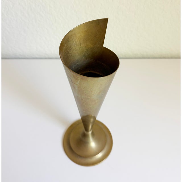 A conical vase with a unique asymmetrical spiral design. Made of solid brass with a wonderful natural patina. A rare find!