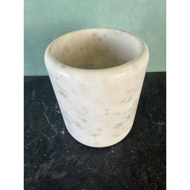 A beautifully understated hand-carved stone vessel, executed in a simple cylindrical form that highlights the natural...
