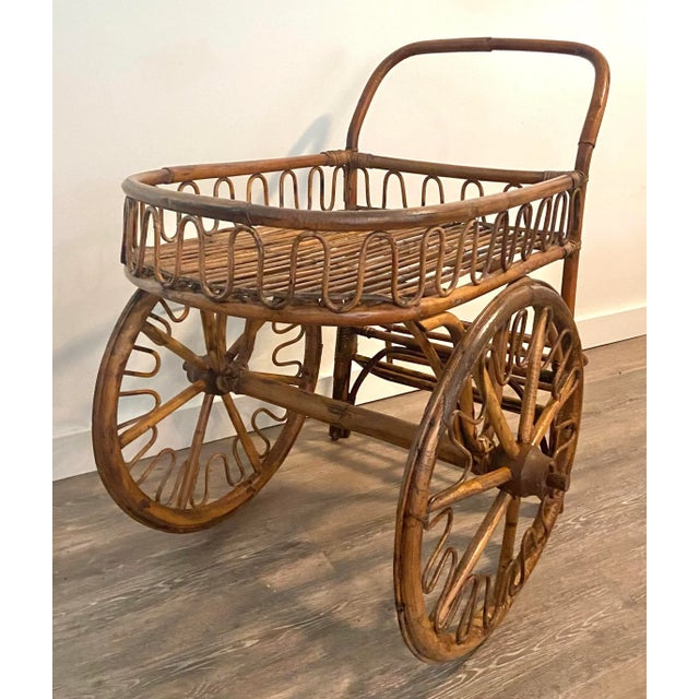 Offered is a vintage rattan French Riveria Bar Cart attributed to famous French designers Adrien Audoux and Frida Minet....